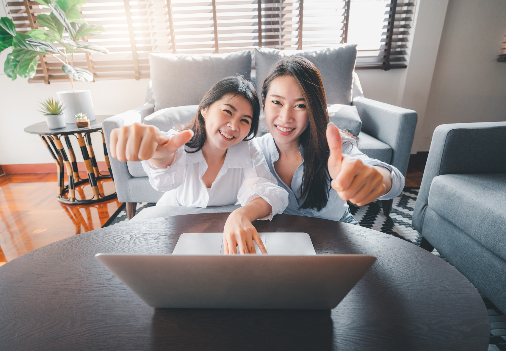Asian Women Friends Using Laptop Doing Thumbs up Gesture