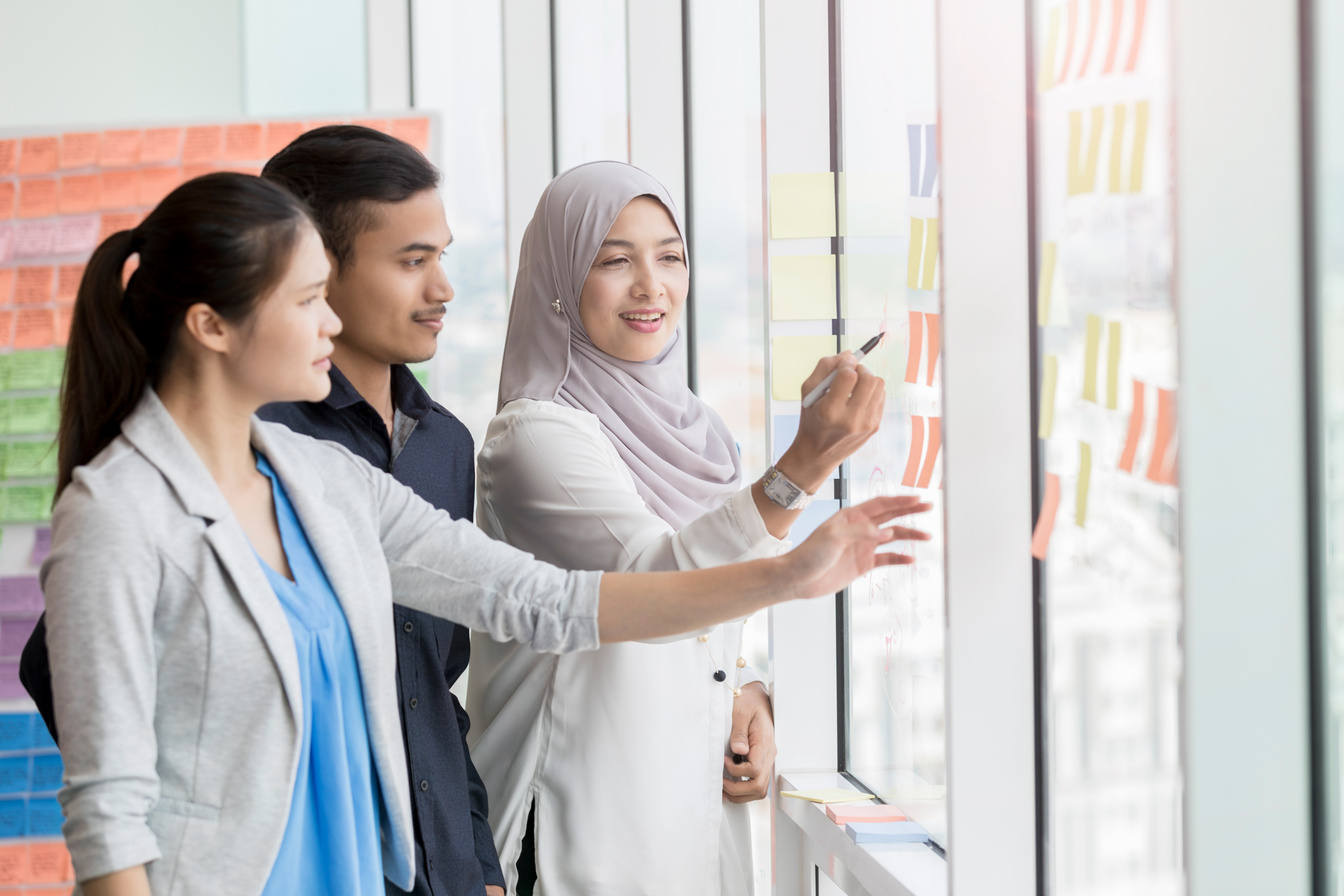 Malaysian coworkers brainstorm ideas together